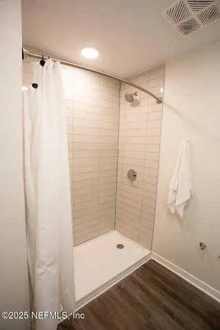 a bathroom with a shower and a tub