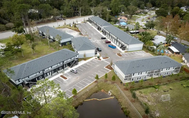 an aerial view of a residential houses with outdoor space
