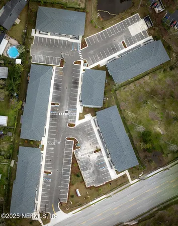 an aerial view of residential houses with outdoor space