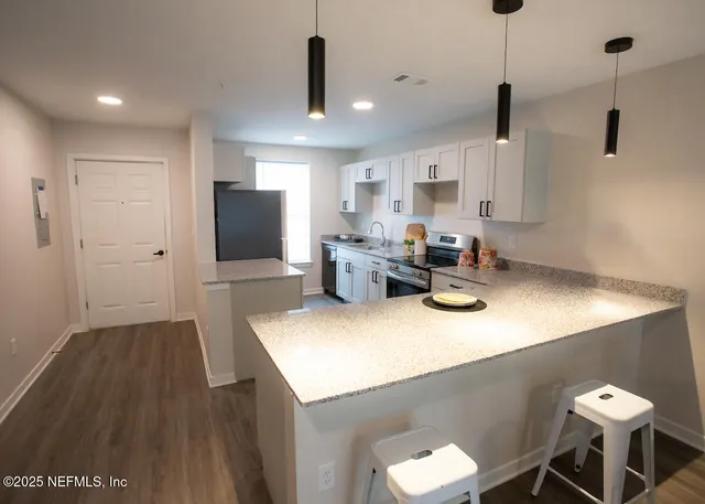a kitchen with a sink appliances and cabinets