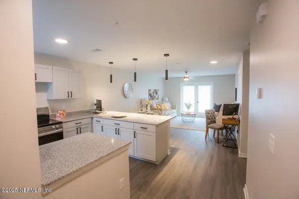 a large kitchen with a table and chairs in it