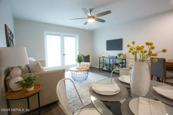 a living room with furniture and a potted plant