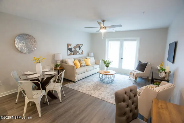 a living room with furniture a window and a chandelier