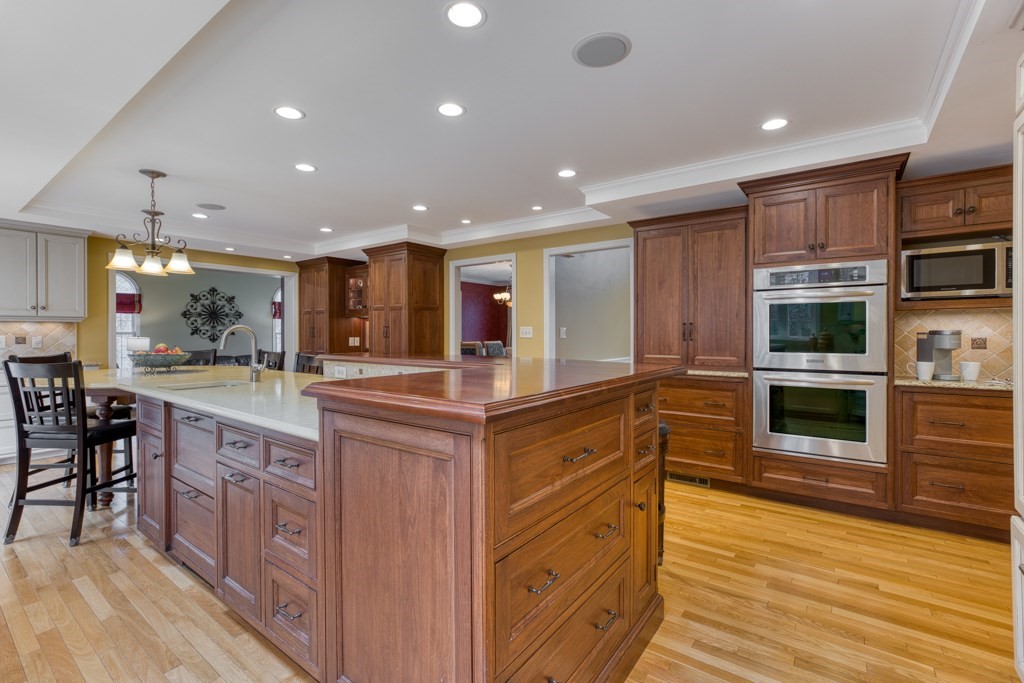 25 Baldpate Road Boxford, MA 01921 - Photo 17 of 42 a kitchen with stainless steel appliances kitchen island granite countertop a stove and a sink