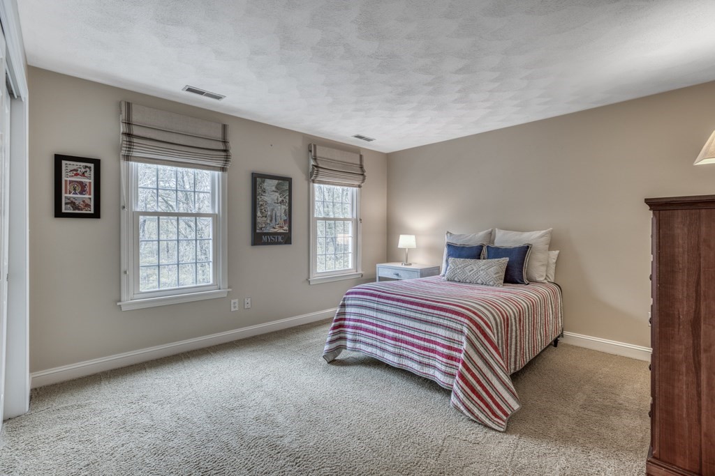 25 Baldpate Road Boxford, MA 01921 - Photo 27 of 42 a bedroom with a bed and window