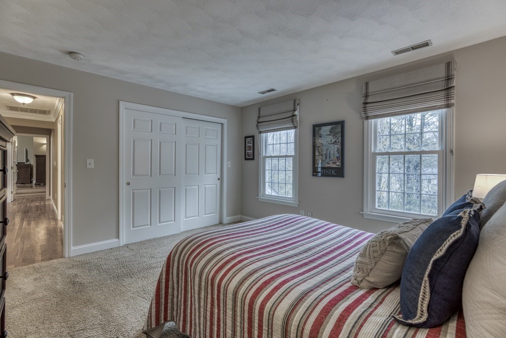 25 Baldpate Road Boxford, MA 01921 - Photo 28 of 42 a bedroom with a bed and glass window