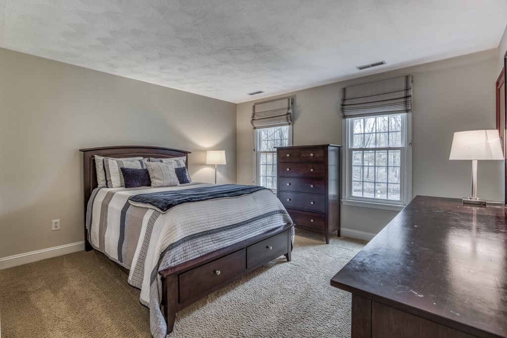 25 Baldpate Road Boxford, MA 01921 - Photo 29 of 42 a bedroom with a bed and wooden floor