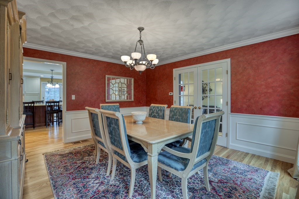 25 Baldpate Road Boxford, MA 01921 - Photo 10 of 42 a view of a dining room with furniture and a chandelier