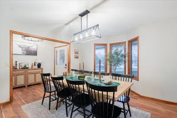 a view of a dining room with furniture window and wooden floor