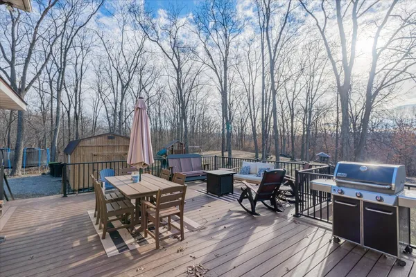 an outdoor space with patio lots of furniture and wooden floor