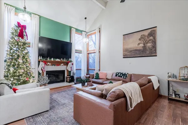 a living room with furniture a flat screen tv and a fireplace