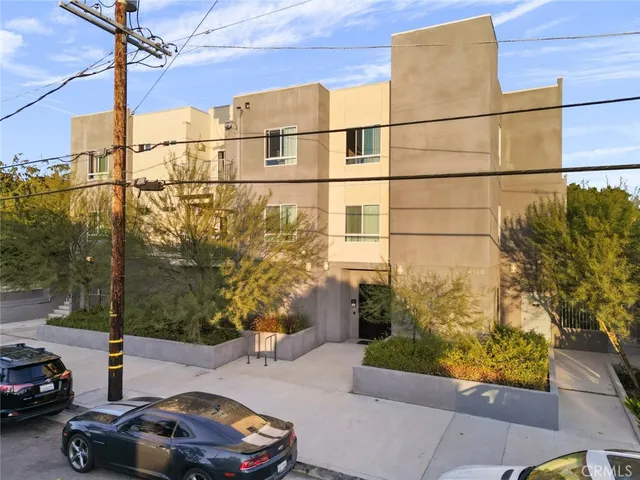 a car parked beside a road next to a building
