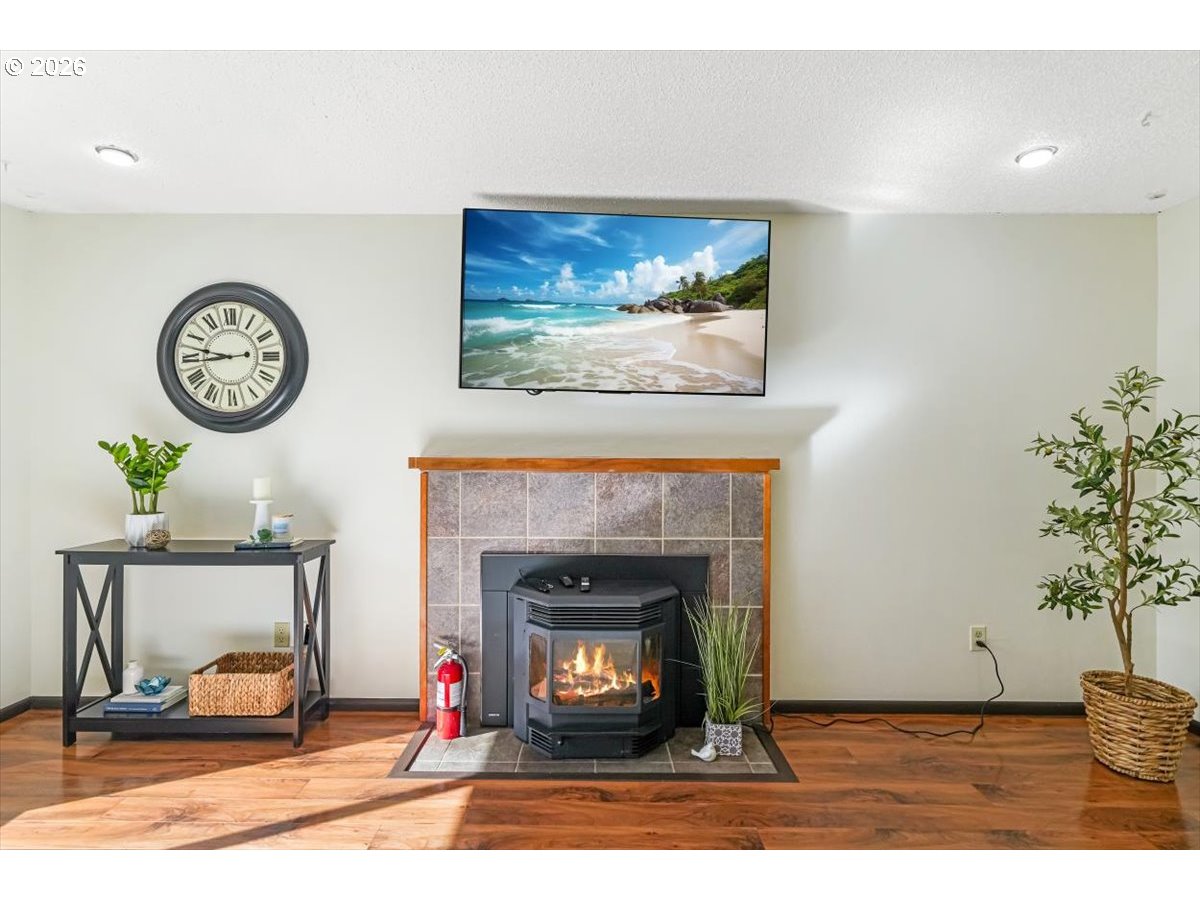 2035 Primrose Loop Philomath, OR 97370 - Photo 41 of 48 a living room with a fireplace and a potted plant
