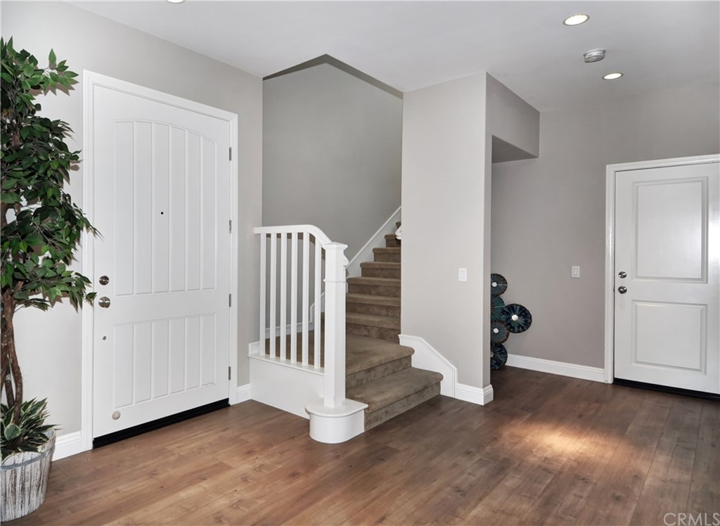 58 Ashdale Irvine, CA 92620 - Photo 8 of 18 an empty room with wooden floor and white walls