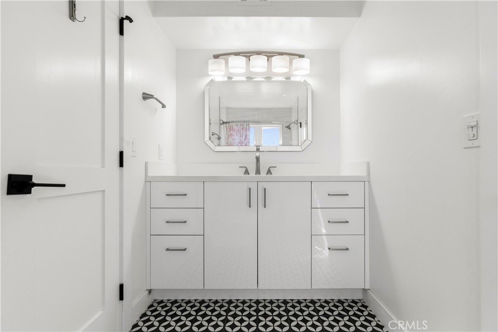 1024 Noria Street Laguna Beach, CA 92651 - Photo 11 of 53 a bathroom with a sink a mirror and a shower