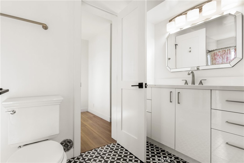 1024 Noria Street Laguna Beach, CA 92651 - Photo 12 of 53 a bathroom with a granite countertop sink a mirror and a toilet