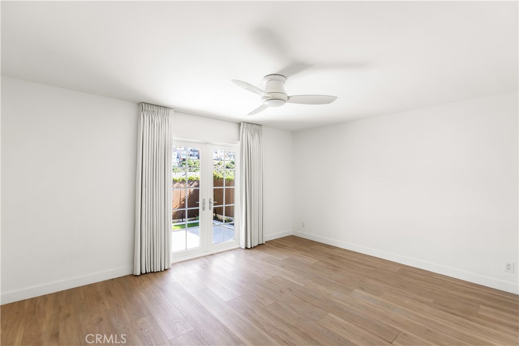 1024 Noria Street Laguna Beach, CA 92651 - Photo 13 of 53 an empty room with wooden floor and ceiling fan
