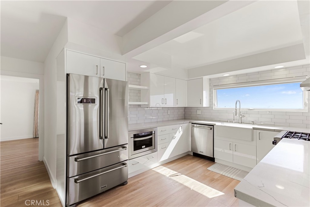 1024 Noria Street Laguna Beach, CA 92651 - Photo 27 of 53 a kitchen with stainless steel appliances a refrigerator sink and microwave