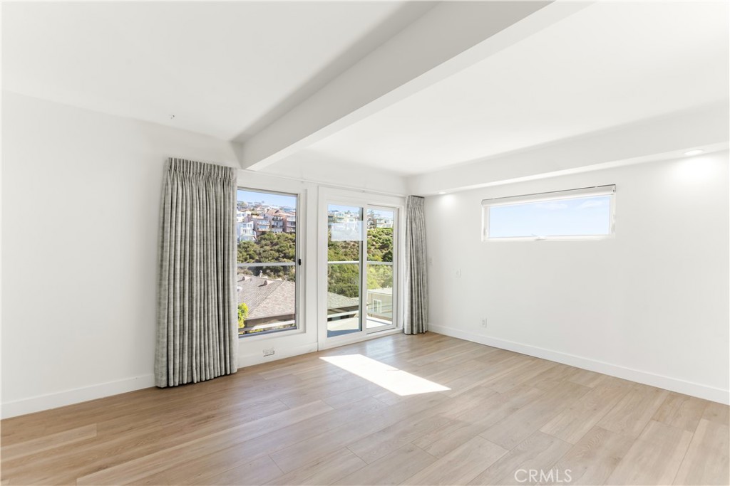1024 Noria Street Laguna Beach, CA 92651 - Photo 29 of 53 an empty room with wooden floor and windows