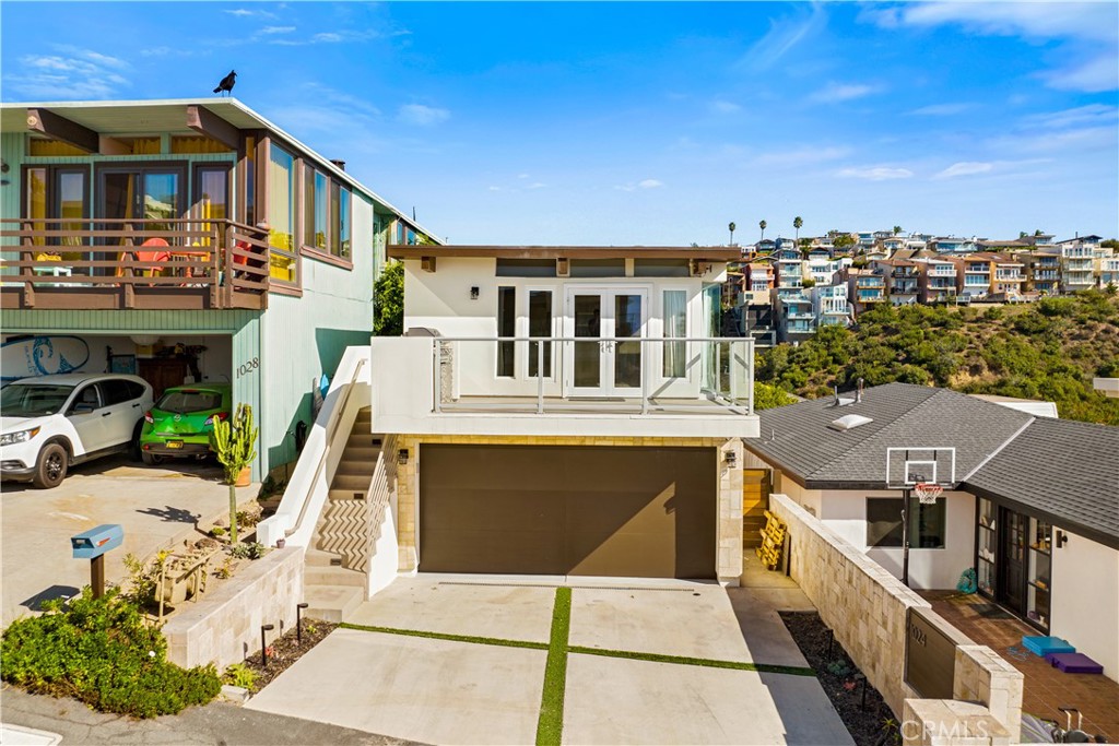 1024 Noria Street Laguna Beach, CA 92651 - Photo 4 of 53 a front view of a building with glass windows and furniture