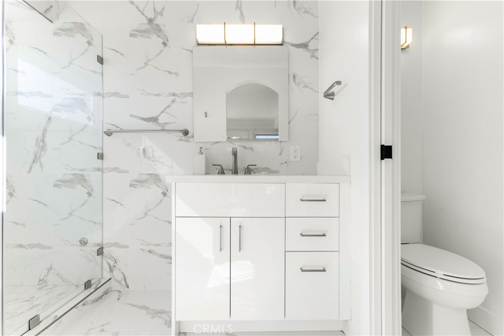 1024 Noria Street Laguna Beach, CA 92651 - Photo 42 of 53 a bathroom with a sink vanity mirror and toilet