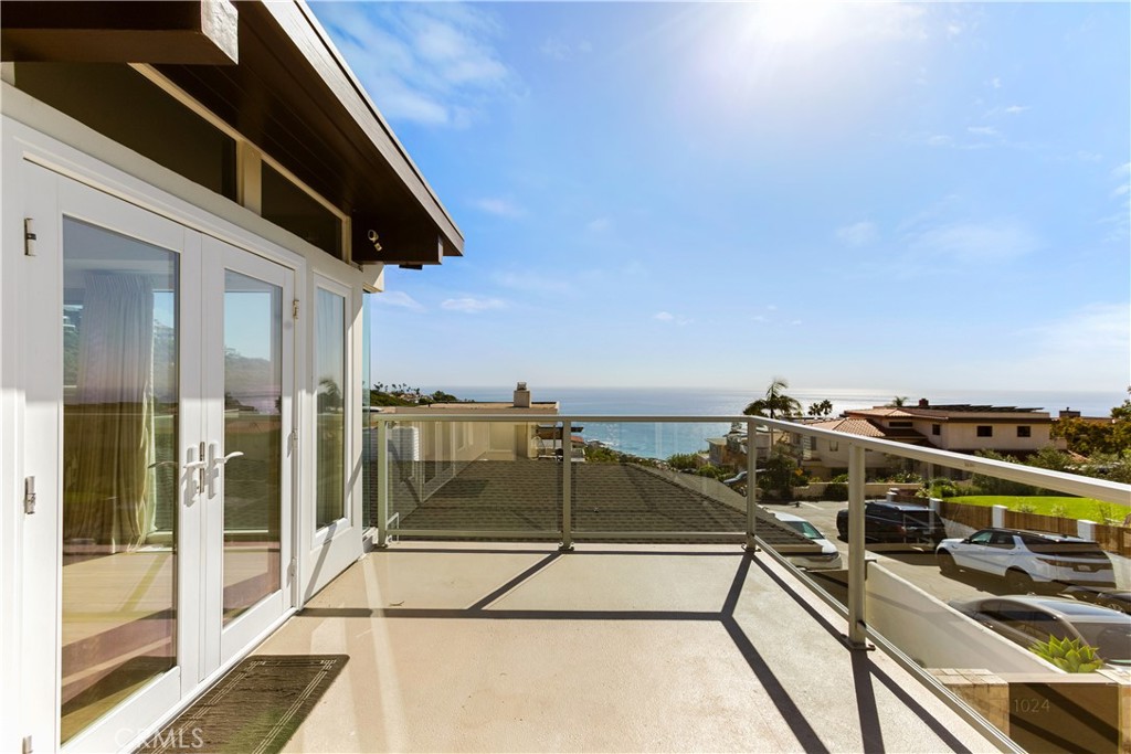 1024 Noria Street Laguna Beach, CA 92651 - Photo 47 of 53 a view of a balcony with two chairs and a barbeque