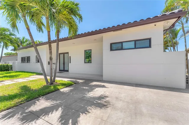 a kitchen with stainless steel appliances granite countertop a sink and a refrigerator