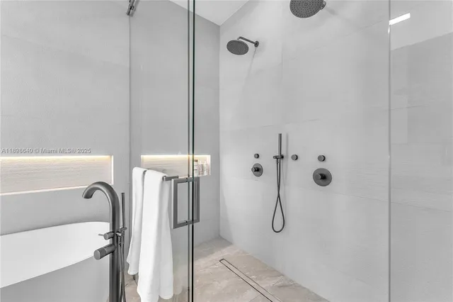 a view of an empty room with wooden floor and windows