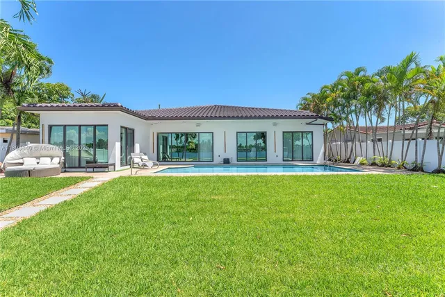 a front view of a house with a garden and yard