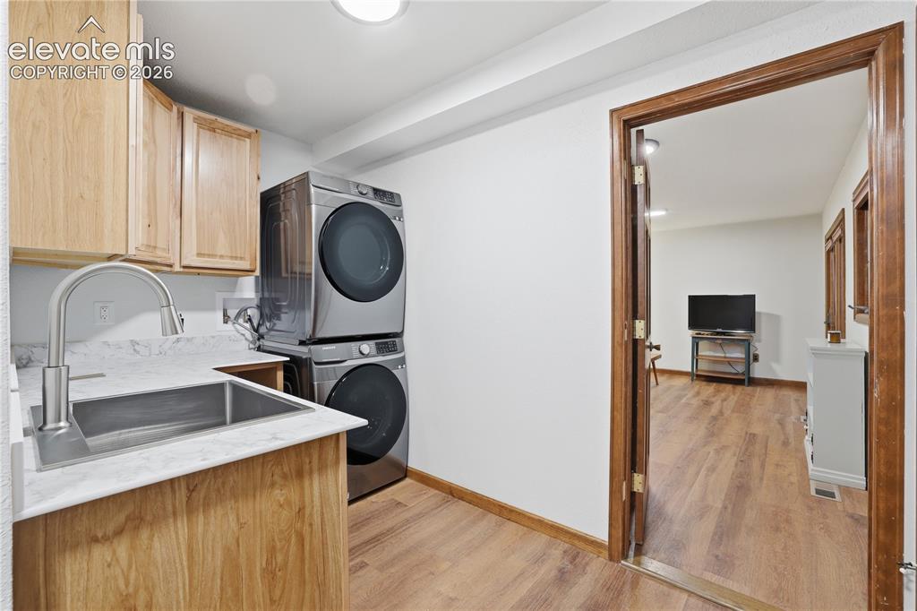 18190 Forest View Road Monument, CO 80132 - Photo 24 of 50 a kitchen with a sink cabinets and a wooden floor