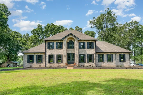 a front view of a house with swimming pool and porch