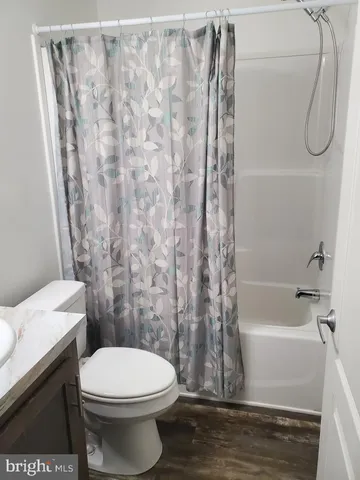 a bathroom with a toilet and shower