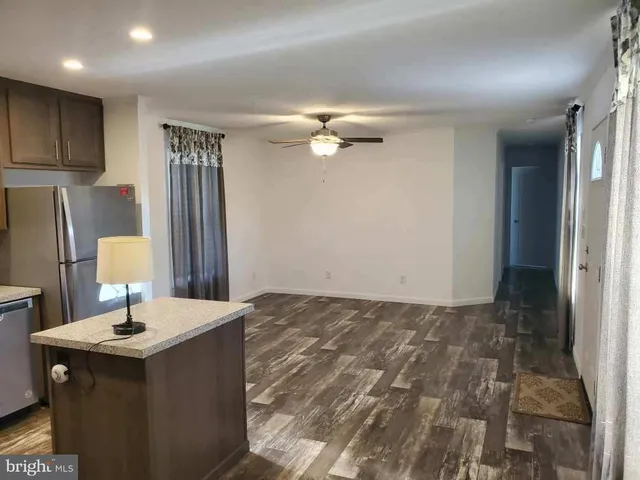 a kitchen with kitchen island a sink appliances and cabinets