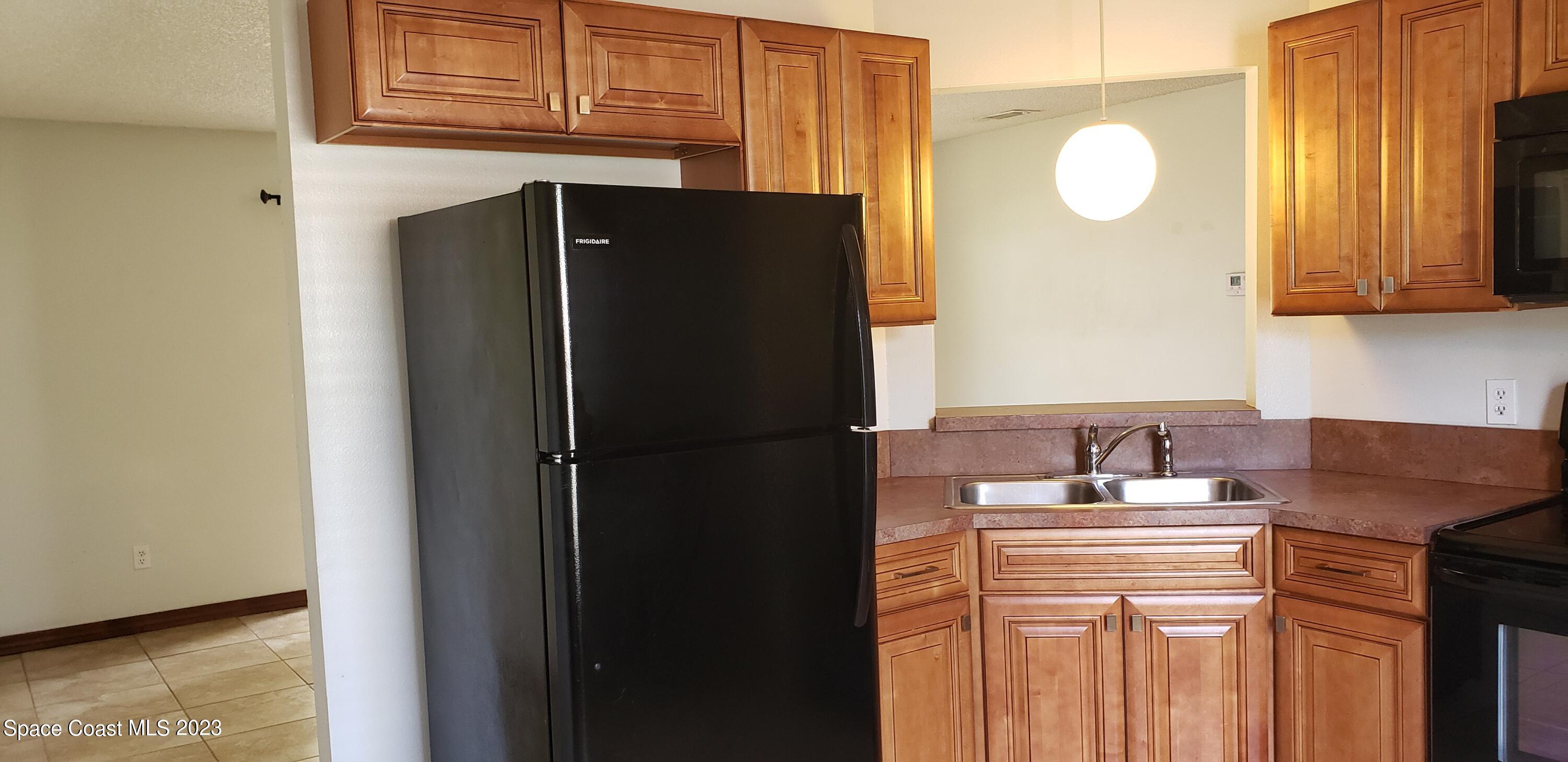 791 Degroodt Road Southwest Palm Bay, FL 32908 - Photo 10 of 47 a kitchen with a refrigerator and a sink