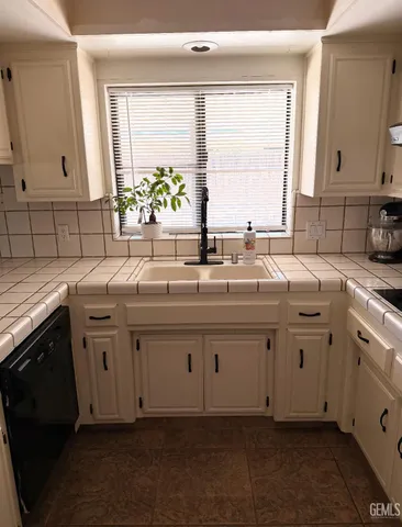 a kitchen with sink cabinets and window