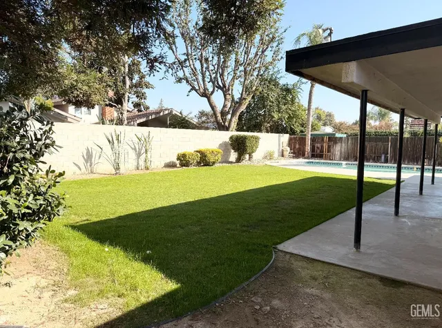 a view of a backyard with swimming pool