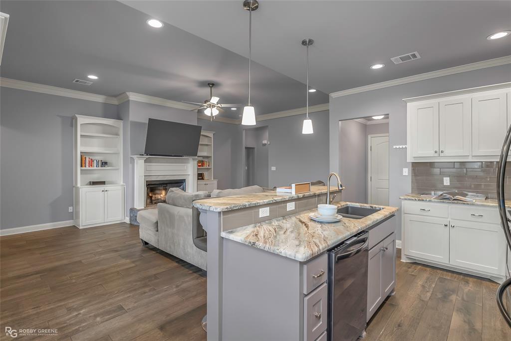 4917 Players Loop Blanchard, LA 71107 - Photo 17 of 31 a kitchen with kitchen island granite countertop a stove and a sink