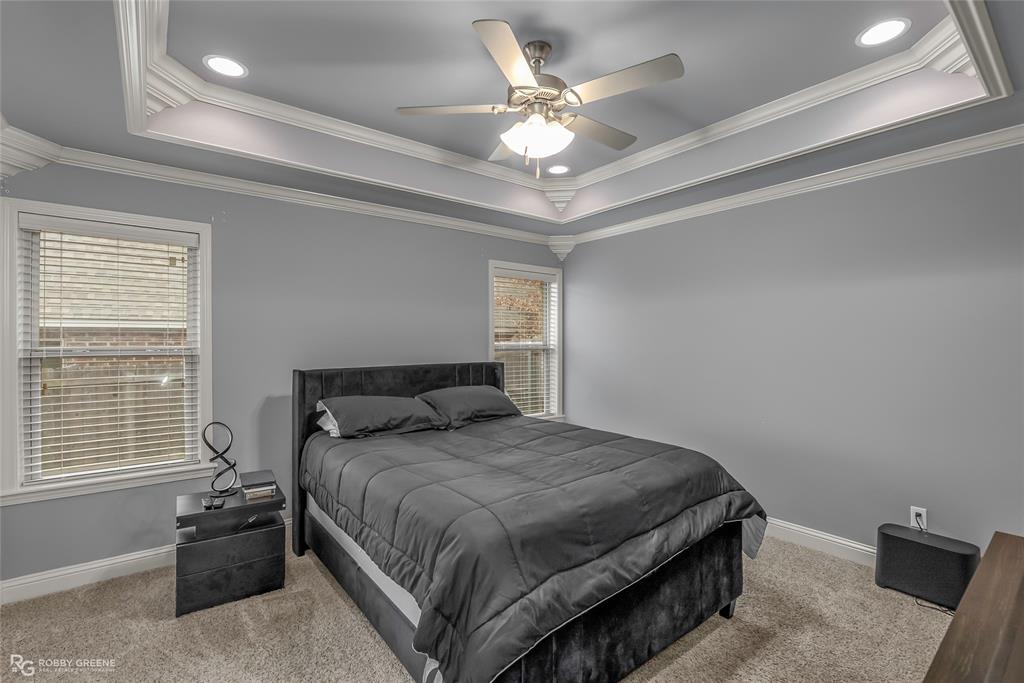 4917 Players Loop Blanchard, LA 71107 - Photo 21 of 31 a bedroom with a bed and a chandelier