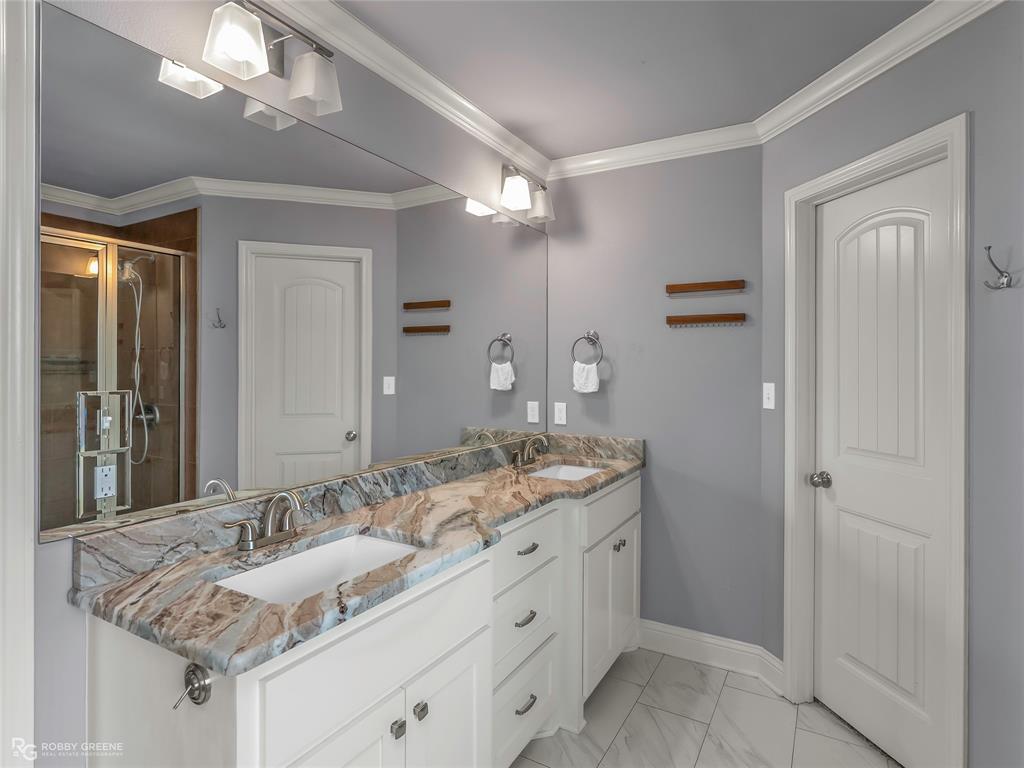 4917 Players Loop Blanchard, LA 71107 - Photo 23 of 31 a bathroom with a granite countertop double vanity sink a mirror and a shower