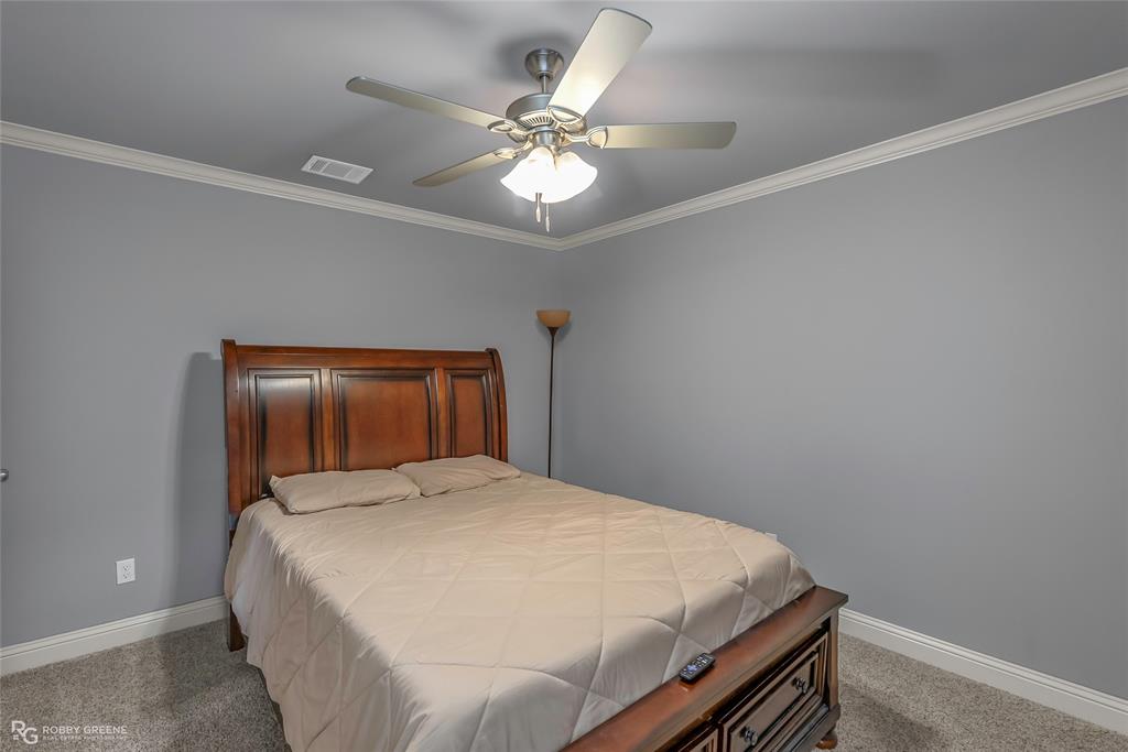 4917 Players Loop Blanchard, LA 71107 - Photo 26 of 31 a bedroom with a bed and a chandelier