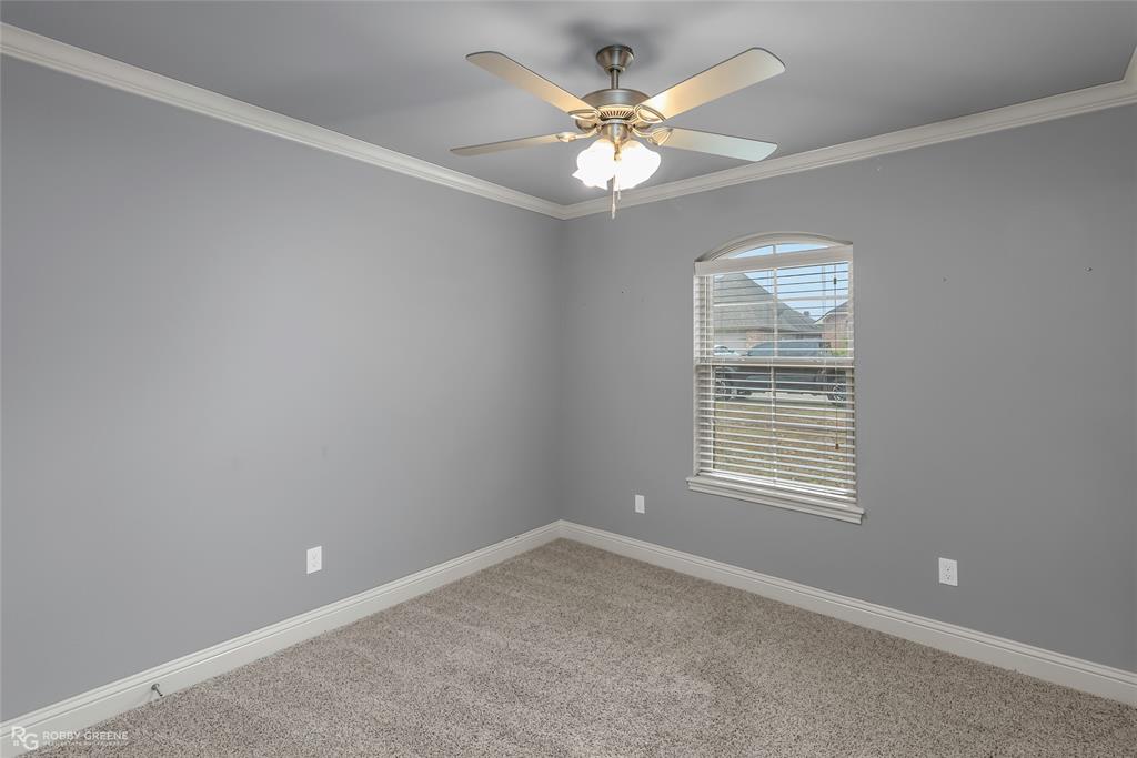 4917 Players Loop Blanchard, LA 71107 - Photo 28 of 31 en empty room with windows and chandelier fan