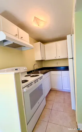 a kitchen with a stove a sink and a refrigerator