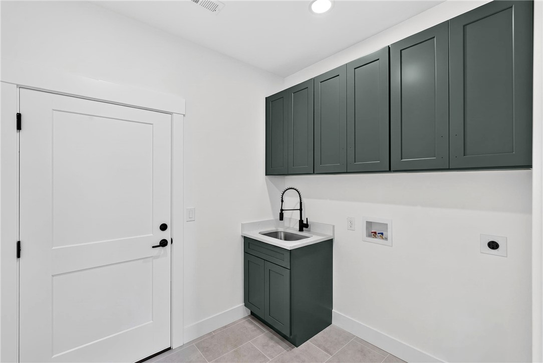 424 Blume Road Anderson, SC 29625 - Photo 26 of 30 Ample storage and a convenient utility sink make laundry day effortless in this well-appointed space.
