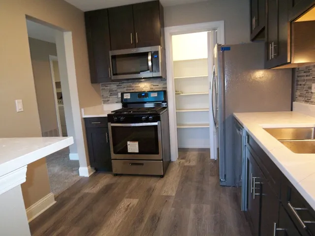 a kitchen with a stove microwave and refrigerator
