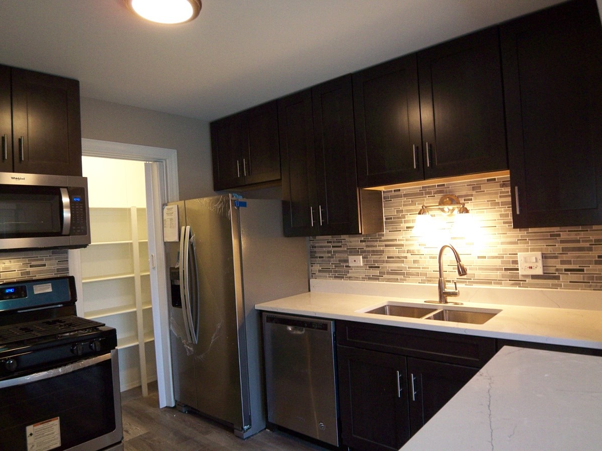 1517 7 Pines Road, Unit C2 Schaumburg, IL 60193 - Photo 13 of 34 a kitchen with a sink stainless steel appliances a refrigerator and a sink