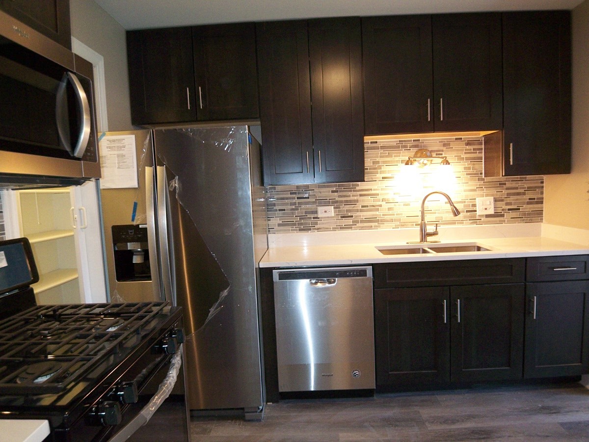 1517 7 Pines Road, Unit C2 Schaumburg, IL 60193 - Photo 14 of 34 a kitchen with granite countertop a refrigerator and a sink