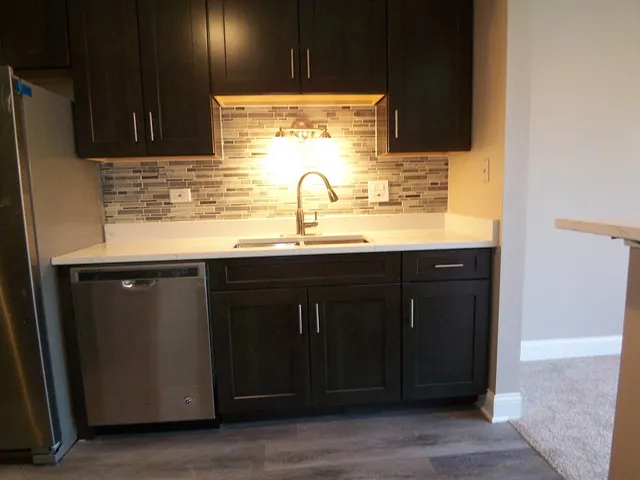 a kitchen with granite countertop a sink and cabinets