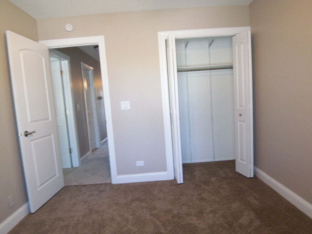 1517 7 Pines Road, Unit C2 Schaumburg, IL 60193 - Photo 29 of 34 an empty room with closet and wooden door