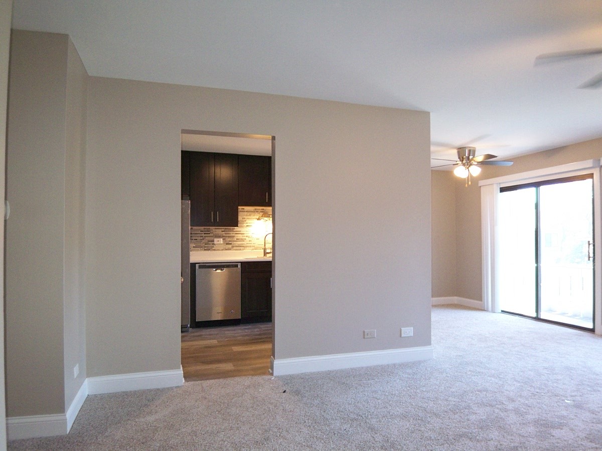 1517 7 Pines Road, Unit C2 Schaumburg, IL 60193 - Photo 3 of 34 a view of an empty room and a kitchen