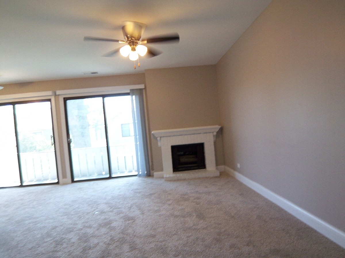 1517 7 Pines Road, Unit C2 Schaumburg, IL 60193 - Photo 5 of 34 an empty room with chandelier fan and windows